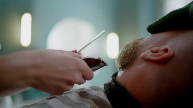 Trendy Barber Carefully Trims the Tips of the Beard of Her Constant Client.