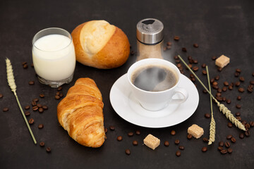 Breakfast in the morning with black coffee cup with bread with Croissant and fruit on the black background.