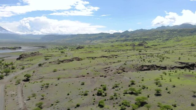 Aerial Flyby View on the Maasai village in on the coast of Natron Lake front of the Ol Doinyo Lengai, Mountain of God in the Maasai language, Engare Sero village in Arusha Region i the Northern