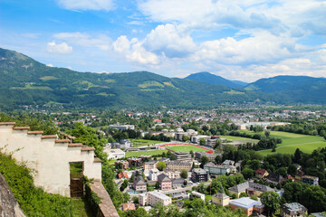 Obraz premium Beautiful cityscape of Salzburg, Austria. Panorama of the city and Alpsfrom above. Beautiful view of buildings and hills on the horizon. 