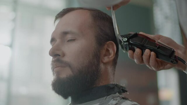 Trendy Barber Makes Elegant Shape of a Beard Using Special Brush and Electric Razor.