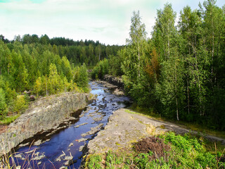 Natural landscape. River with rocky shores in the forest. Karelia, Russia.