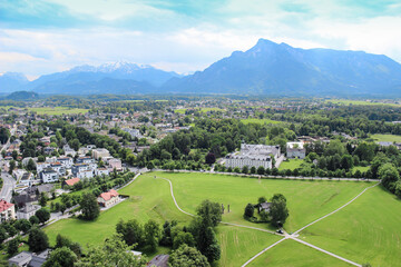 Fototapeta na wymiar Panorama of the city from above, Salzburd, Austria. Beautiful view of buildings and mountains on the horizon.