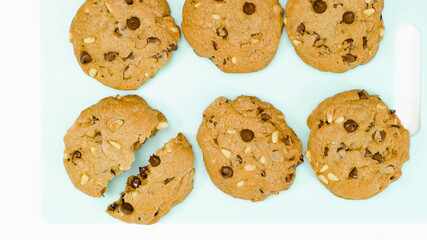 Chocolate Chip Cookies with pine nuts close up on a serving board. Homemade old-fashioned Chocolate Chip Cookies. American cuisine, dessert