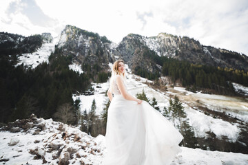 Beautiful bride spinning with perfect dress in the park
