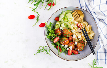 Italian pasta. Conchiglie with meatballs, feta cheese and salad on light background. Dinner. Top view, overhead. Slow food concept