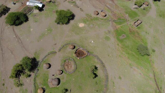 Aerial Flyby View on the Maasai village in on the coast of Natron Lake front of the Ol Doinyo Lengai, Mountain of God in the Maasai language, Engare Sero village in Arusha Region i the Northern