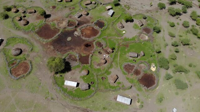 Aerial Flyby View on the Maasai village in on the coast of Natron Lake front of the Ol Doinyo Lengai, Mountain of God in the Maasai language, Engare Sero village in Arusha Region i the Northern