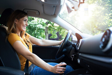 Naklejka premium Car interior view of female driver enjoys driving a car. Woman driving automobile.