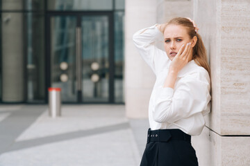 Fototapeta premium Portrait of a young surprised woman in a stylish black and white business suit