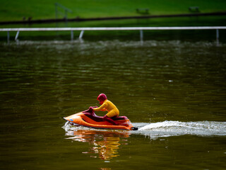 RC controlled jet ski model on lake. Active summer vacation for school child.