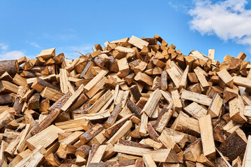 huge pile of firewood against the sky