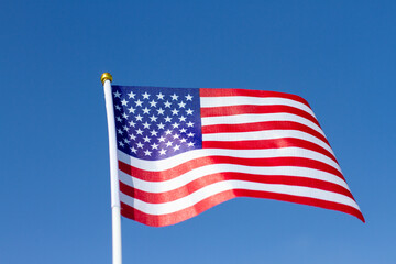 USA flag waving in blue sky. American flag. Celebrating Independence Day of America