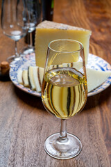 Spanish fino sherry wine from Andalusia and pieces of different sheep hard manchego cheeses made in La Mancha, Spain. Wine and cheese pairing
