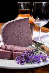 Cheese collection, pieces of violet hard cheese made with aromatic lavender seeds and fresh lavender flowers