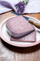Cheese collection, pieces of violet hard cheese made with aromatic lavender seeds and fresh lavender flowers