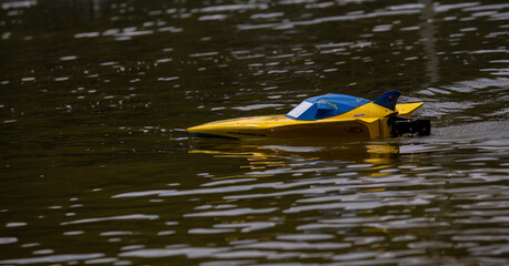 RC controlled jet boat model on lake. Active summer vacation for school child.