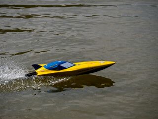Plakat RC controlled speedboat model on lake. Active summer vacation for school child.