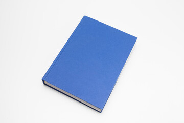Blue book with no title standing on white background