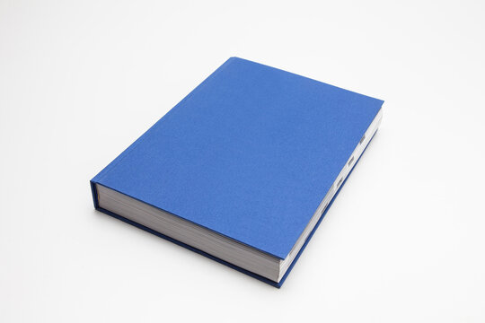 Blue book with no title standing on white background