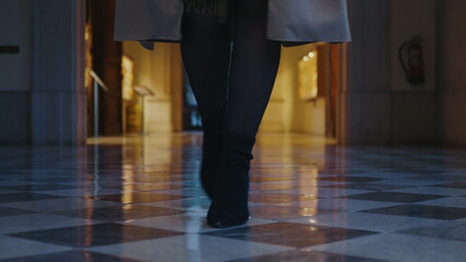 Fototapeta premium Student legs walking in hall at university. Businesswoman walking in hallway