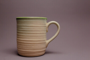 white ceramic cup on gray background.