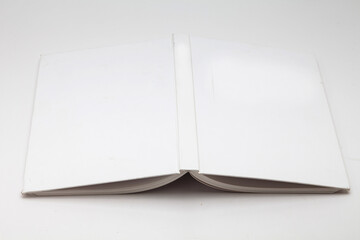 White book with no title standing on white background