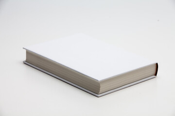 White book with no title standing on white background