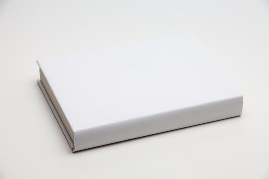 White book with no title standing on white background
