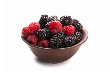 Raspberry, blackberry and mint leaf in ceramic brown bowl isolated on white