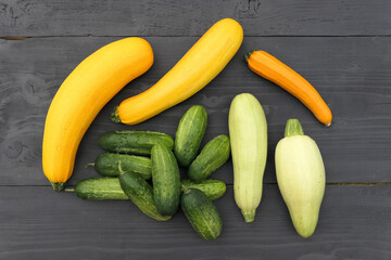 Yellow and white zucchini squash and green cucumbers.