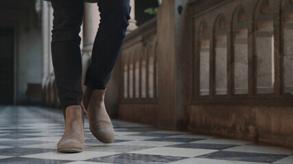 Student feet walking in university building. Businessman legs going for work