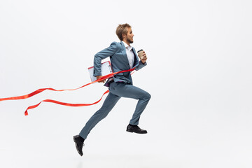 Fototapeta na wymiar Career, success. Man in office clothes running, jogging on white background like professional athlete, sportsman. Unusual look for businessman in motion, action with ball. Sport, healthy lifestyle