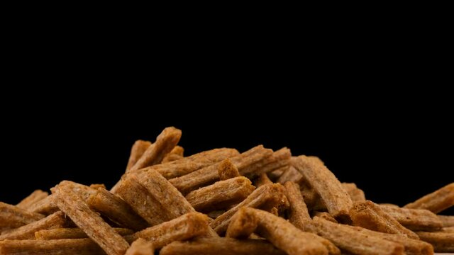 Breadcrumbs rotate on a black background. Beer snack. Close up