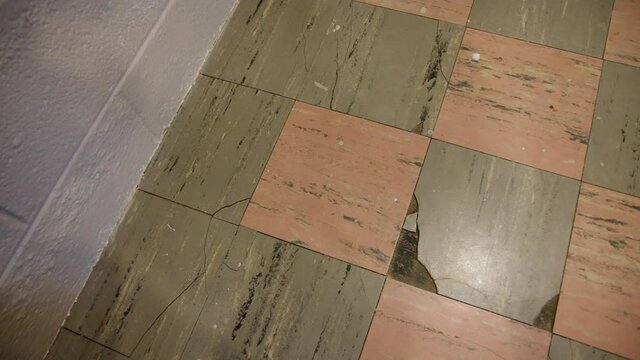 Overhead View of Damaged Cancerous Asbestos Vinyl Flooring that is Cracked Broke