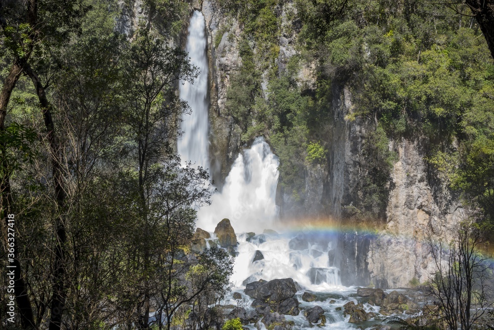 Poster Amazing shot of the Tarawera Falls with a visible rainbow in New Zealand