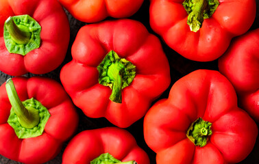 a few red bell peppers. background vegetables