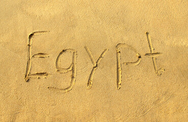 Egypt word on beach sand. Egypt letters is written on a sand. Handwriting