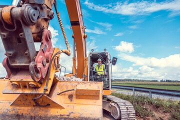 Woman construction worker with excavator on sit © Kzenon