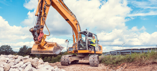 Woman construction worker with excavator on sit