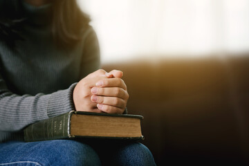 Asian young woman pray with bible