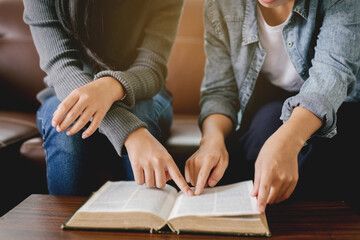 Two women studying the bible.