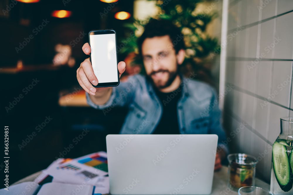 Poster selective focus cellular with mock up blank screen for advertise website in hands.blurred man holdin