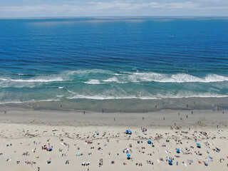 Aerial view of people at the beach during blue summer day. Pacific Beach in San Diego, California 