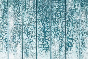 cracked white paint textured background on teal blue wooden planks