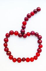 Obraz premium Red cherry ripe juicy on a white background.