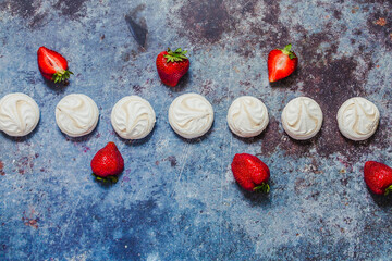 White marshmallows and strawberries with coffee on a blue metal background..Free space for text.Top view.Holiday and festive food concept