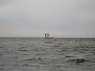 Obraz premium Lonely boat in the stormy sea