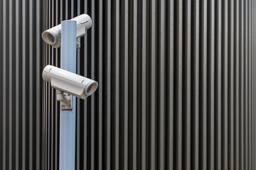 security surveillance cameras against modern urban background