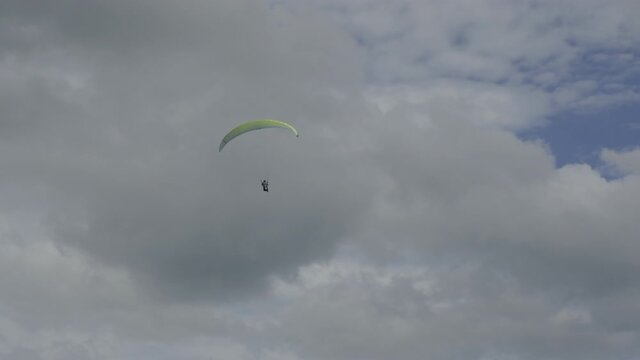 A paraglider flying into the skies